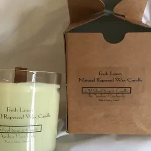 a candle with a box and a label