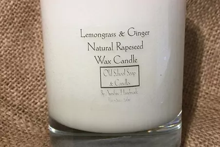 a candle with a label that reads lemon and ginger