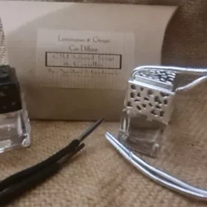 a small bottle of perfume and a small bottle of nail polish